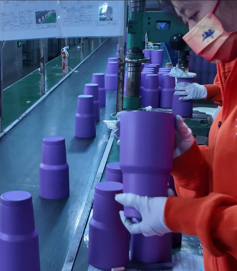 Bulk production line of stainless steel tumblers and coffee mugs in factory warehouse with high capacity manufacturing