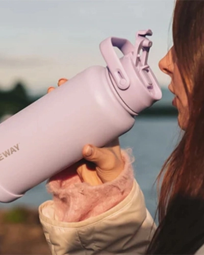 Direct sip insulated water bottle with handle used for outdoor hydration and active lifestyles