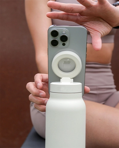 Magnetic water bottle phone mount replacing tripod for hands-free video recording
