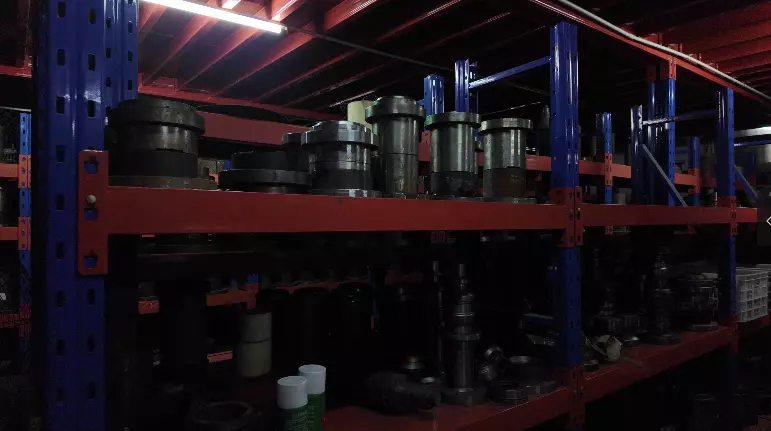 A close-up photograph of a precision mold for stainless steel drinkware being inspected and verified in an industrial tooling facility.